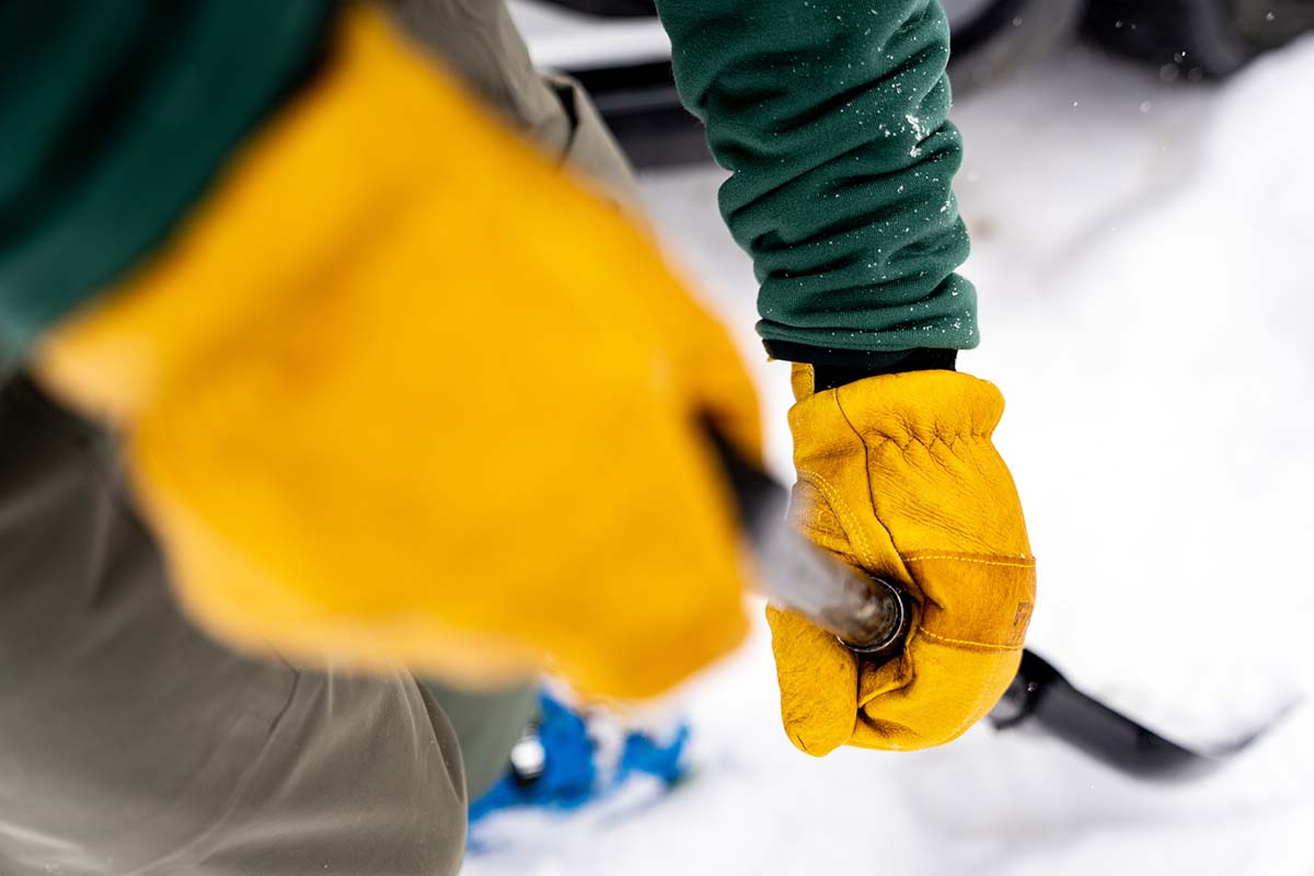 Shoveling snow with leather glove