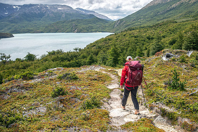 Osprey Aura AG LT 65 backpacking pack (hiking on trail above lake)