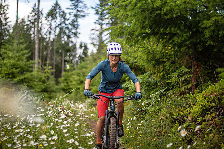 POC Kortal Race MIPS mountain bike helmet (riding on trail with wildflowers)