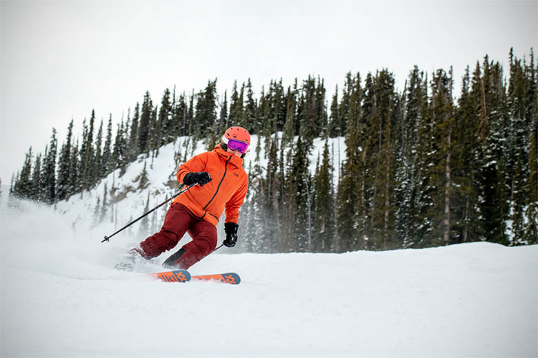 Woman in White Jacket and Black Pants Standing on Snow Covered Ground with  Skis · Free Stock Photo