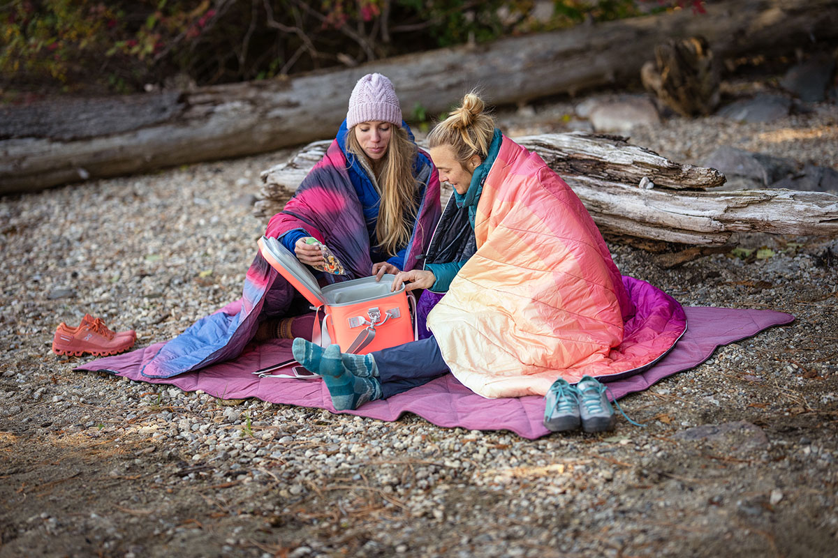 Camping blankets (Rumpl Original Puffy and Kelty Galactic wrapped around shoulders)