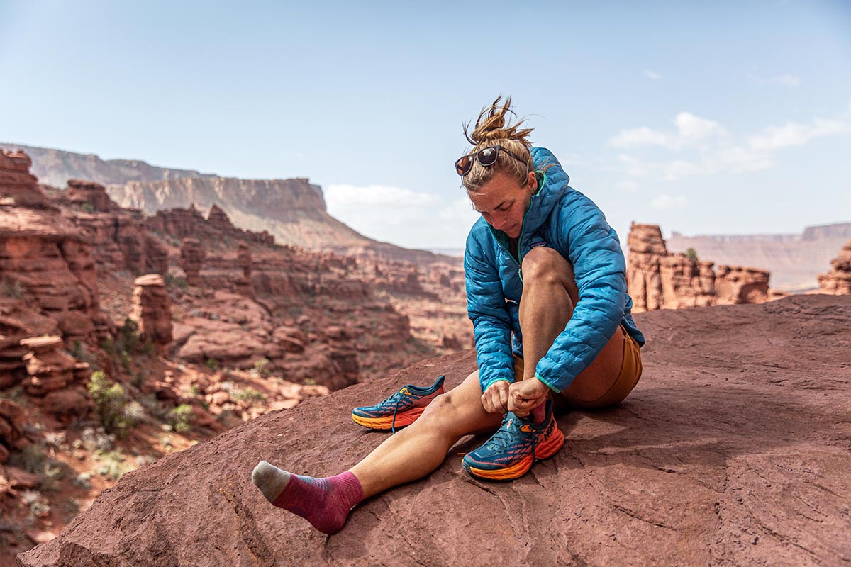 Hiking shoes (lacing up Hoka One One Speedgoat trail runners)