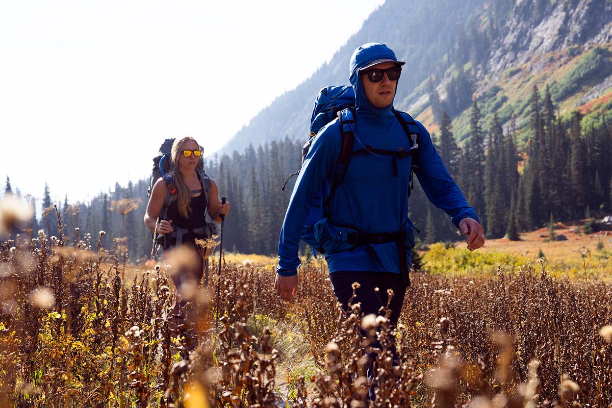 Hiking through meadow wearing sun shirt (Outdoor Research Echo Hoody)