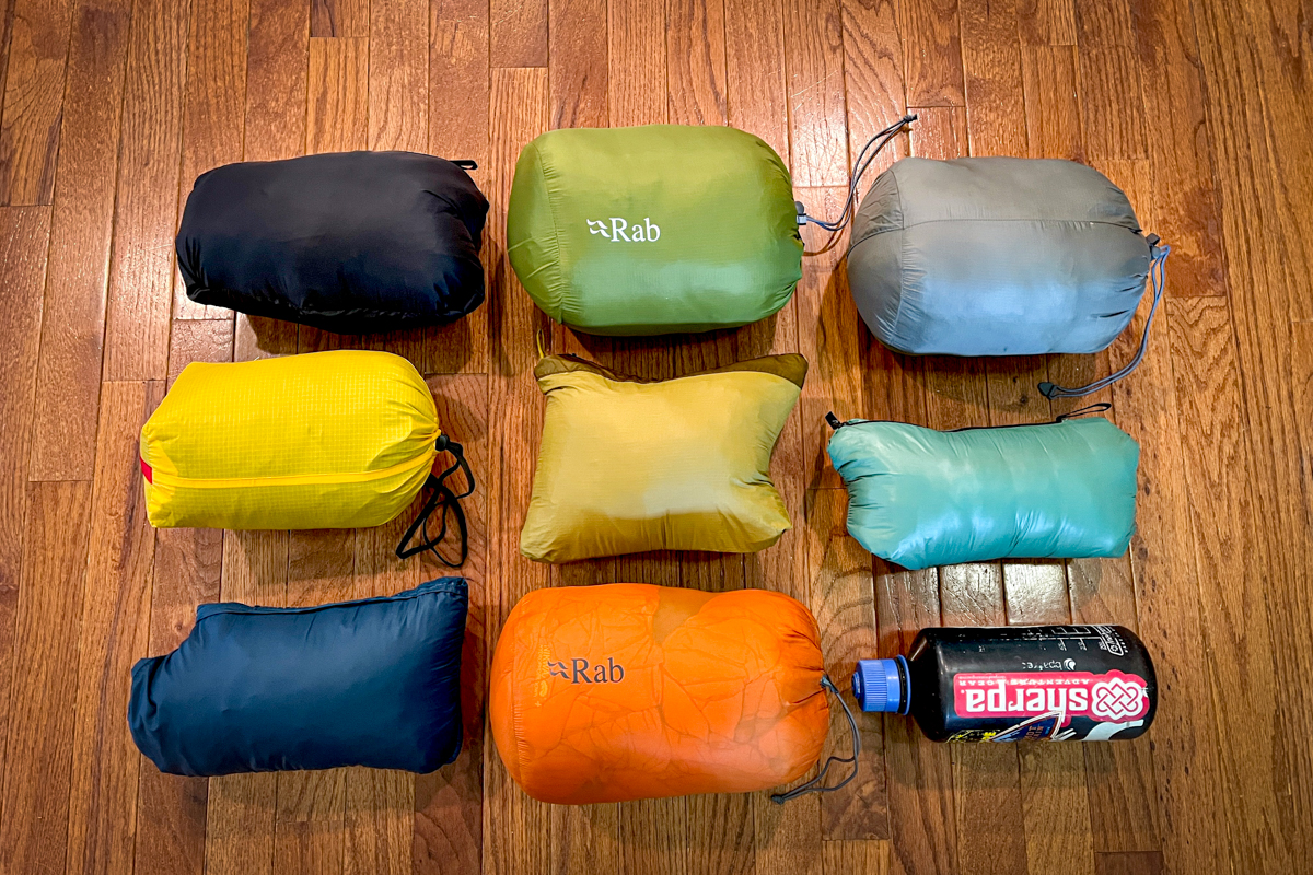 Men's Down Jackets lined up in stuff sacks