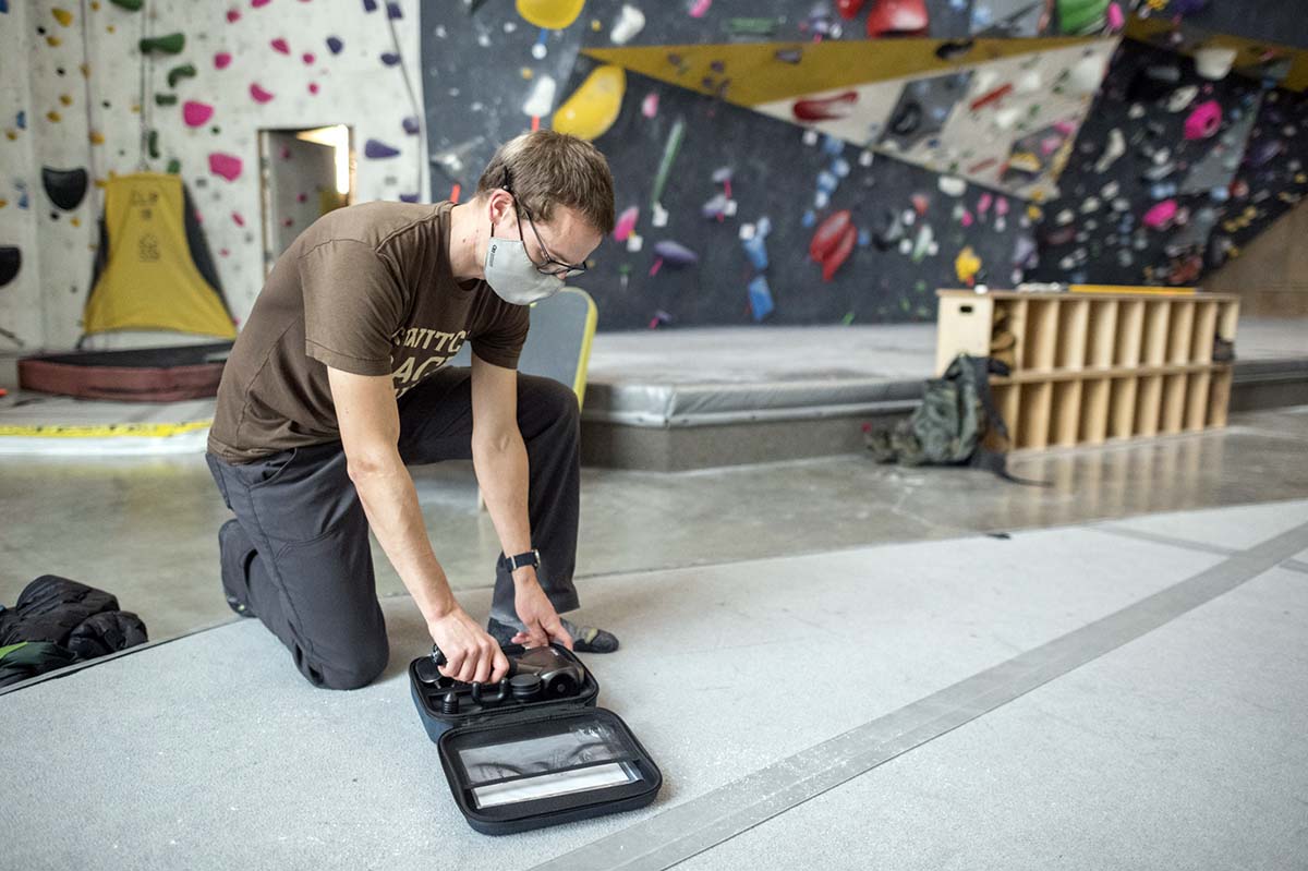 Percussion massager (travel case in climbing gym)