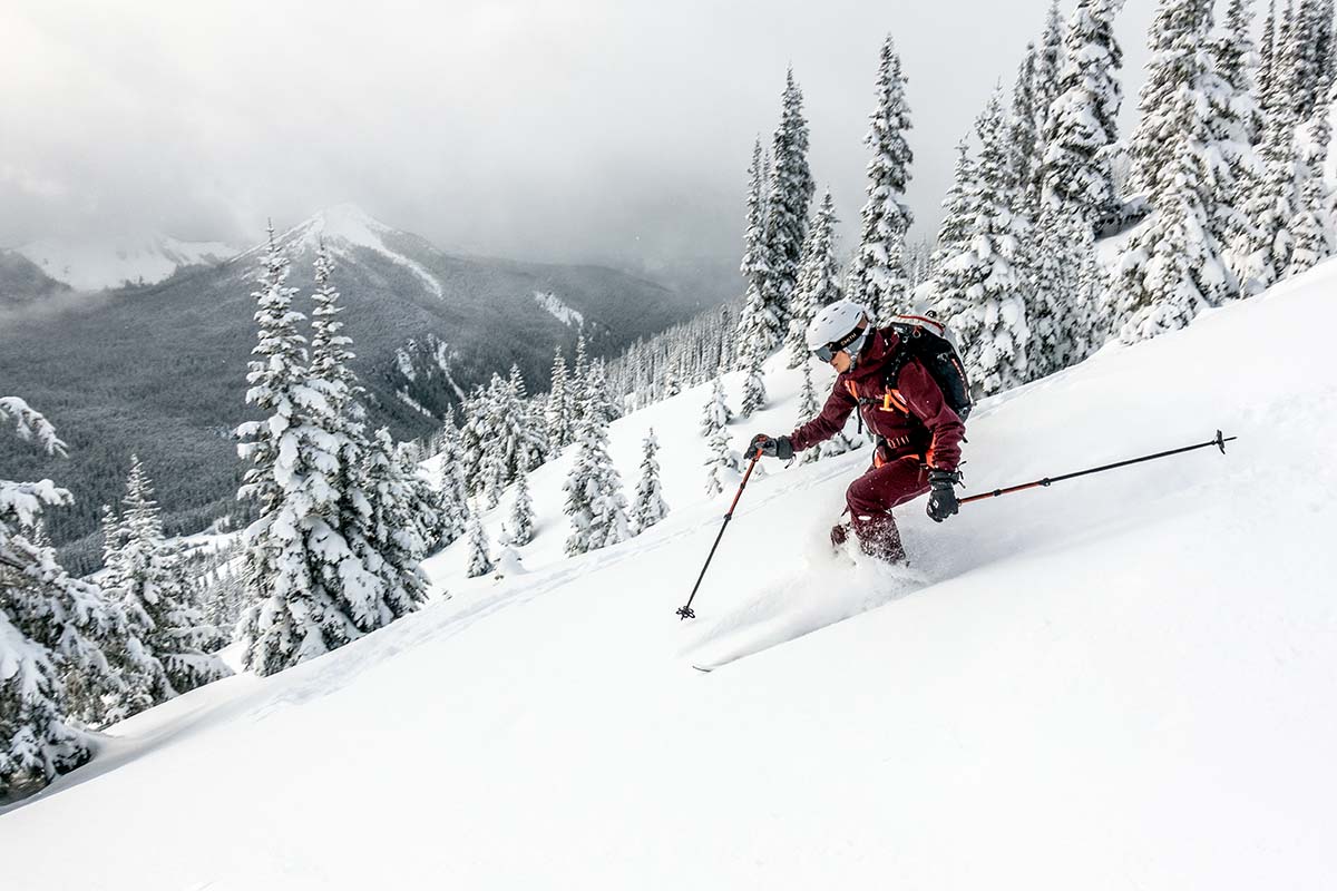 Skiing downhill through powder wearing Arc'teryx Sentinel kit