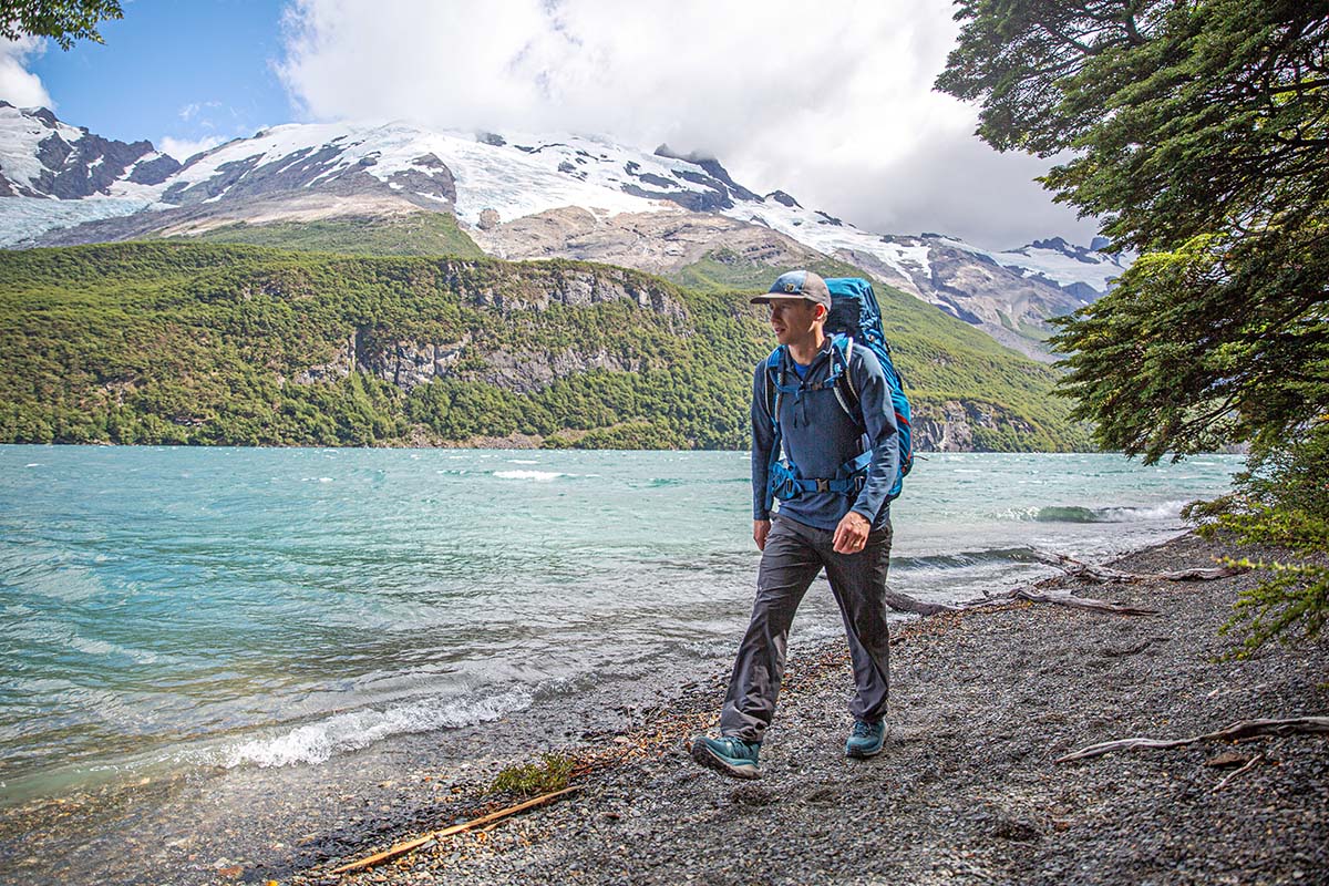 Backpacking beside lake in baselayer