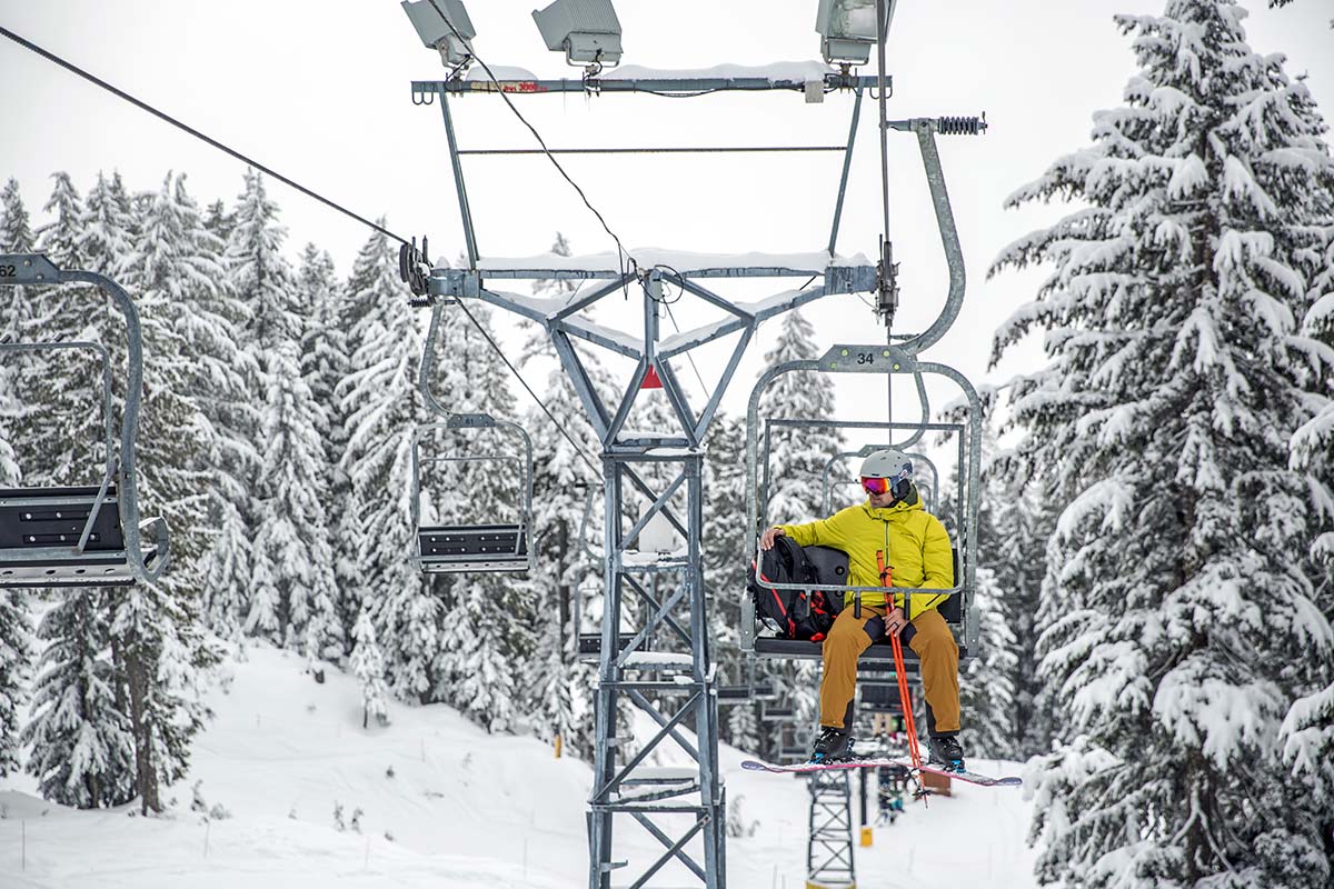 Riding chairlift with ski backpack