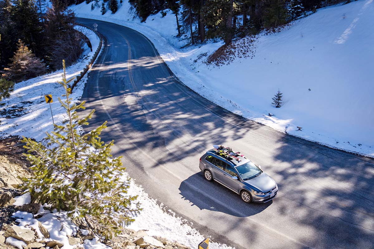 Driving up mountain road (ski snowboard rack on car)