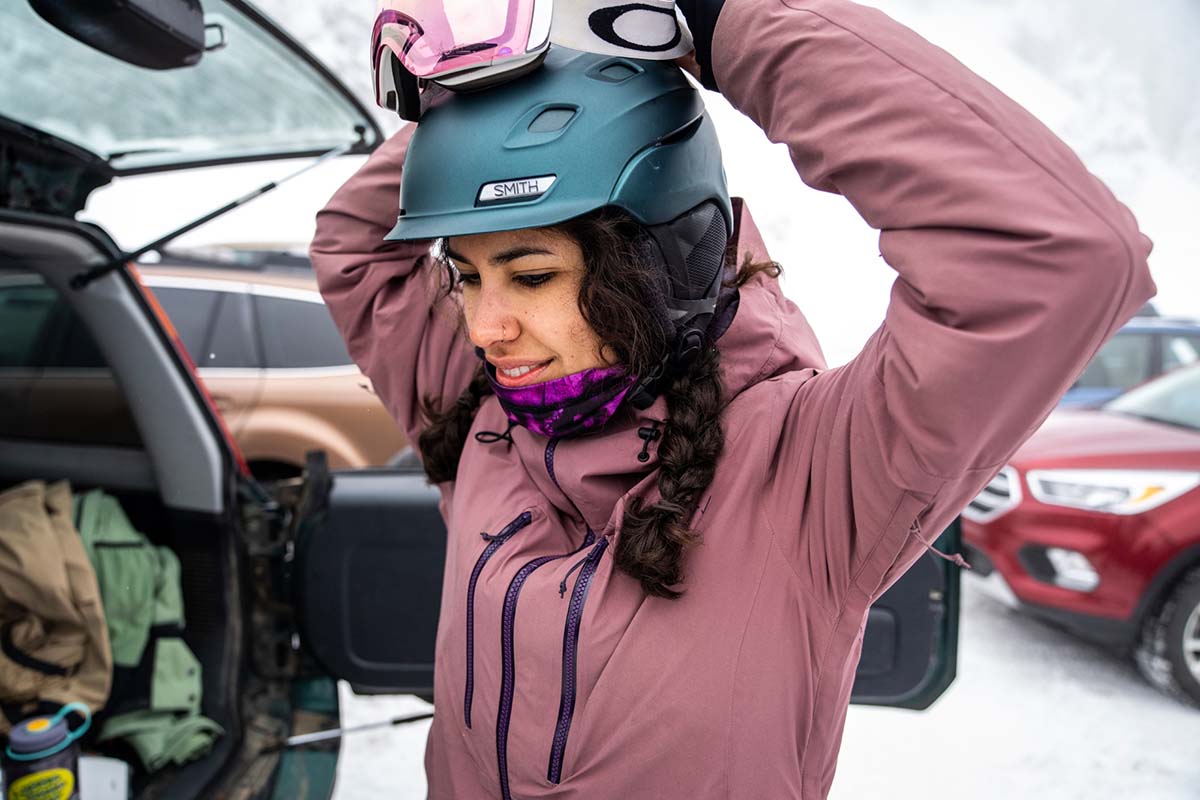 Putting on Smith Vantage snow helmet in resort parking lot