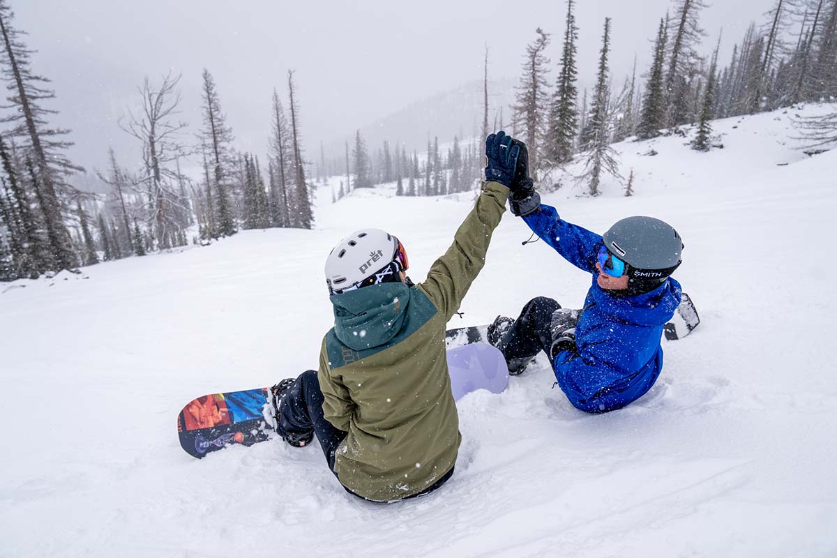 Sitting while snowboarding (high fives)