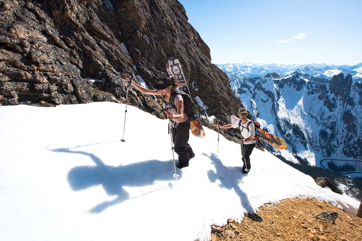 Bootpacking in mountains (carrying snowboards on backpack)