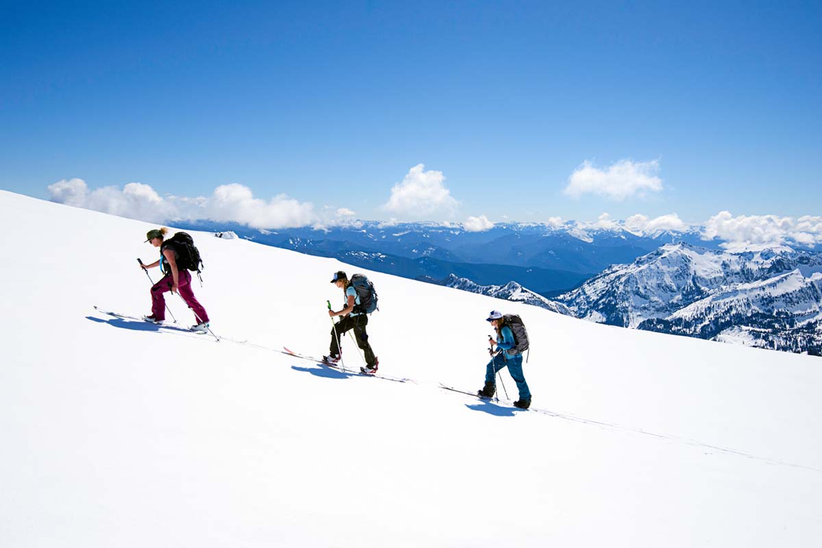 Group skinning uphill in mountains (splitboarding)