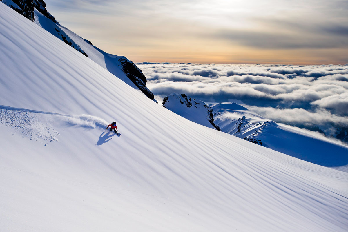 Splitboarding above the clouds (wide turn)