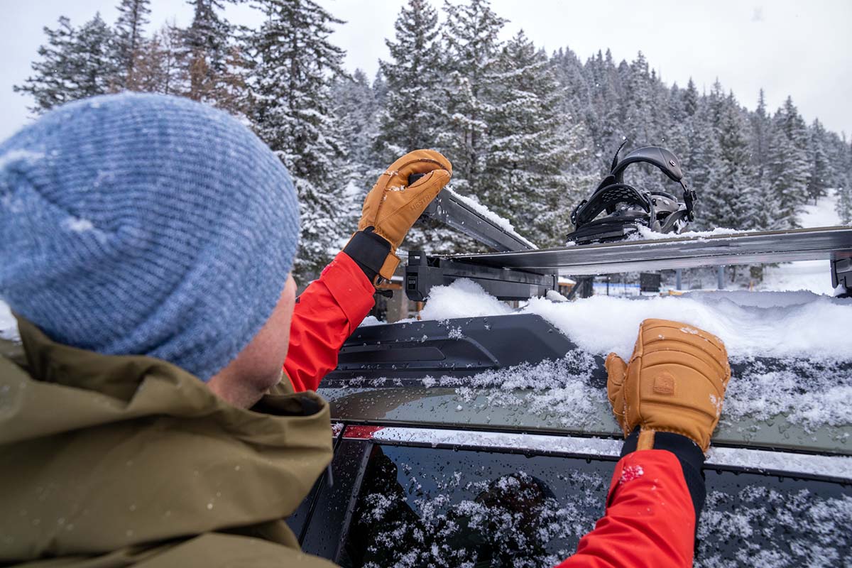 Opening a rooftop ski rack with winter gloves