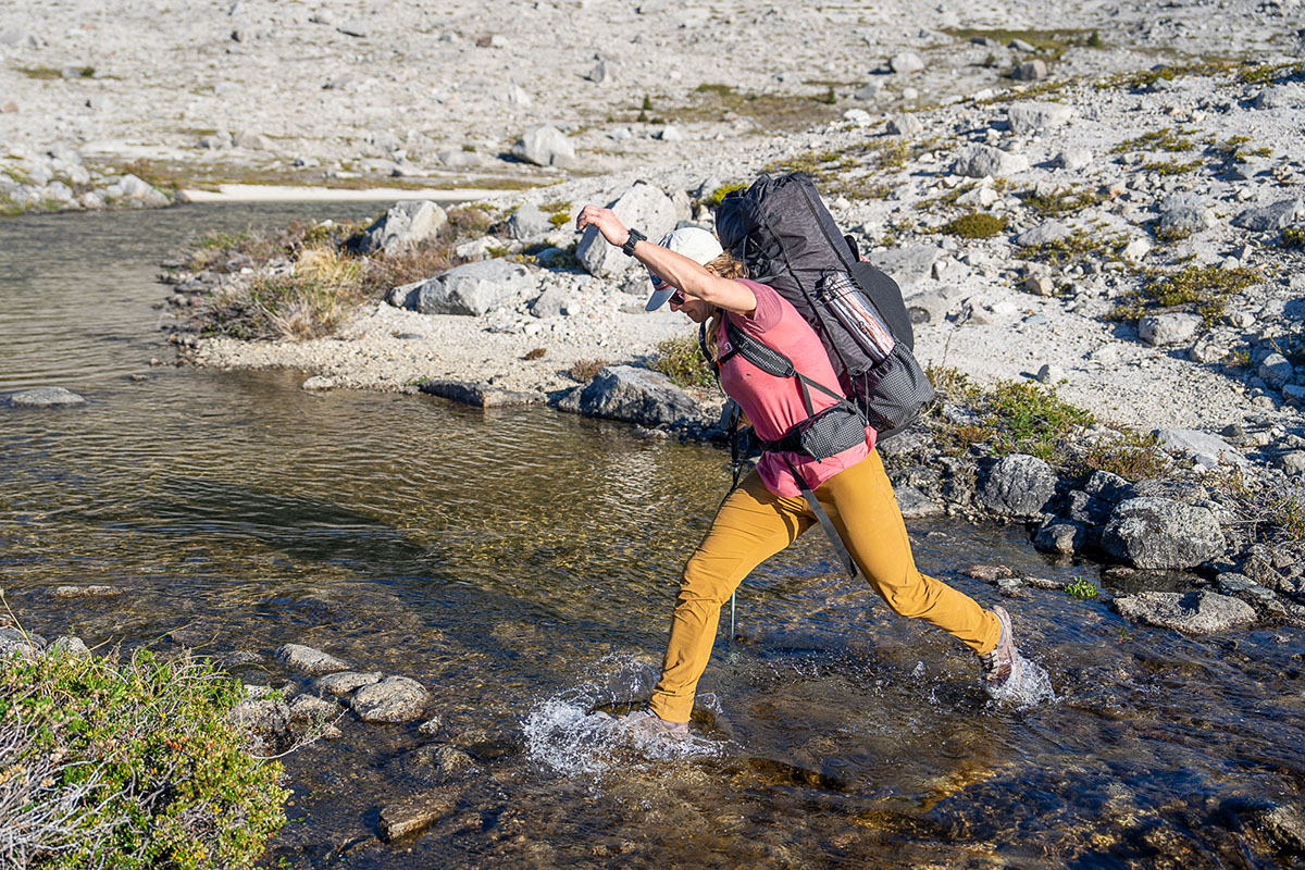 Women's hiking pants (jumping across stream in Black Diamond Alpine Light Pants)