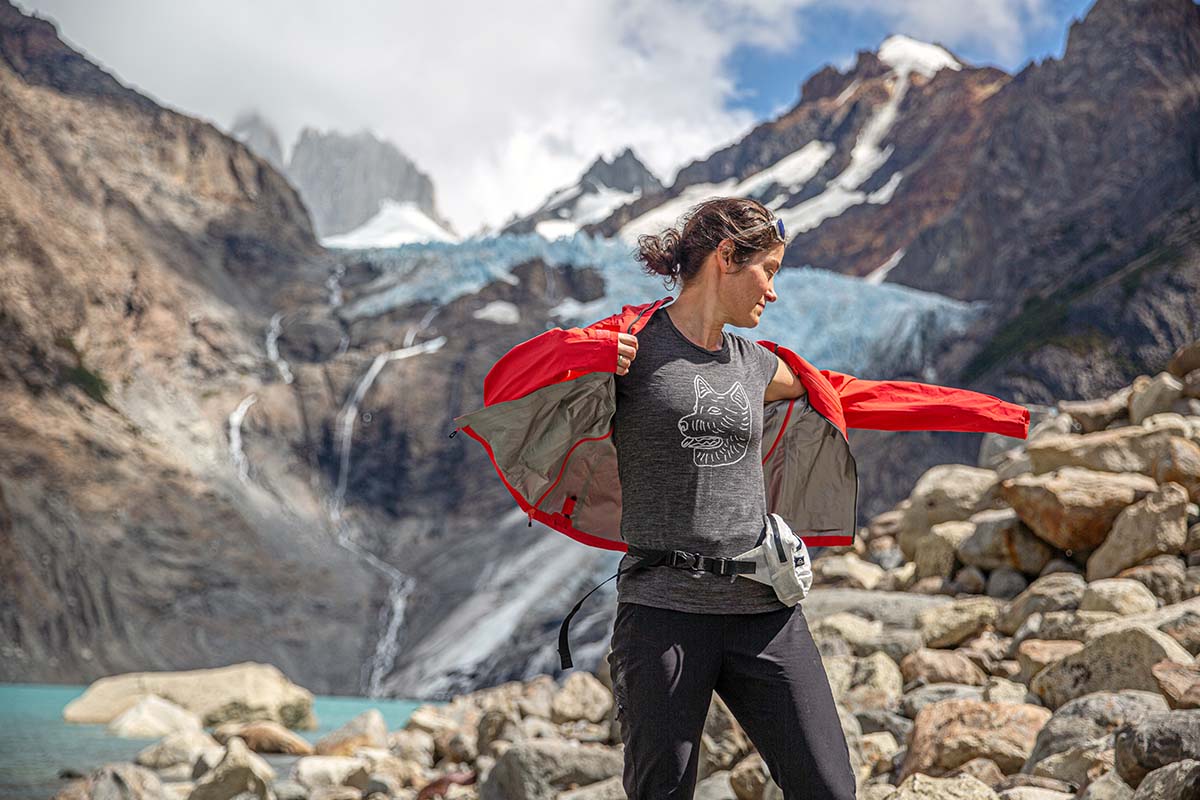 Layering a rain jacket over a hiking shirt (glacial lake)