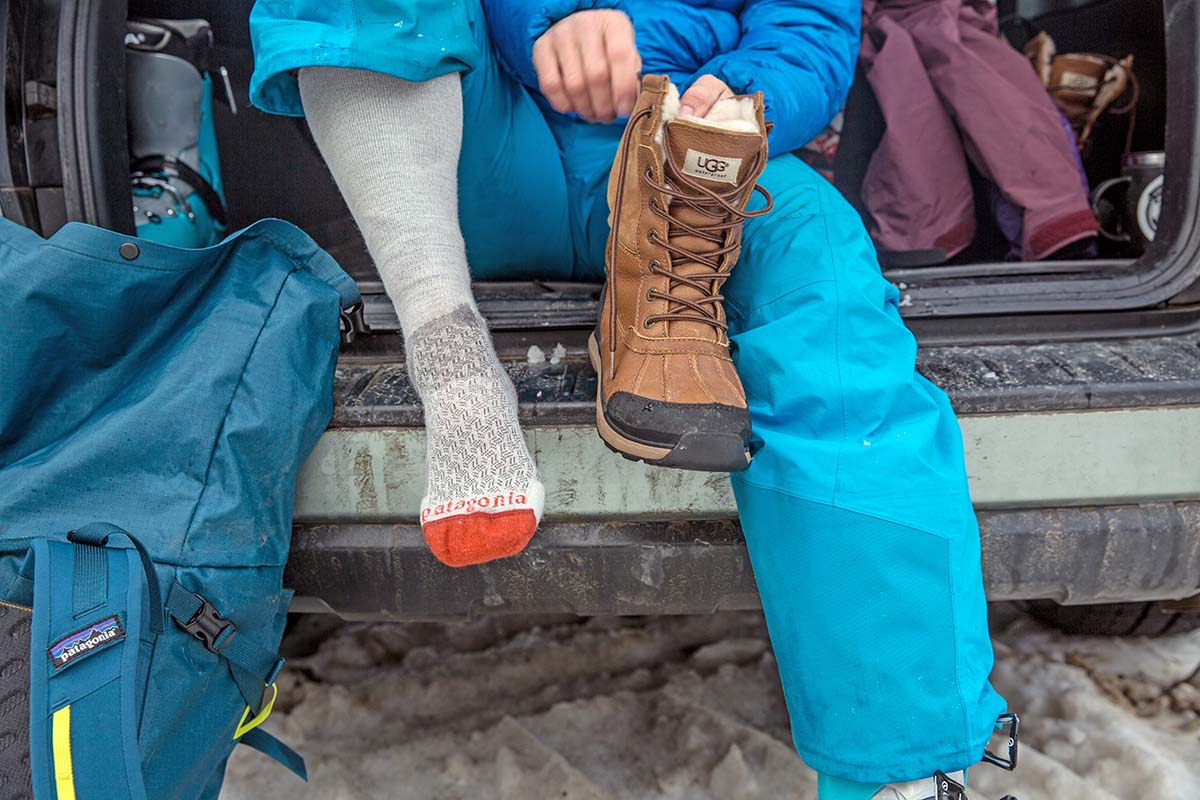Putting on the UGG Adirondack III women's winter boot (socks)