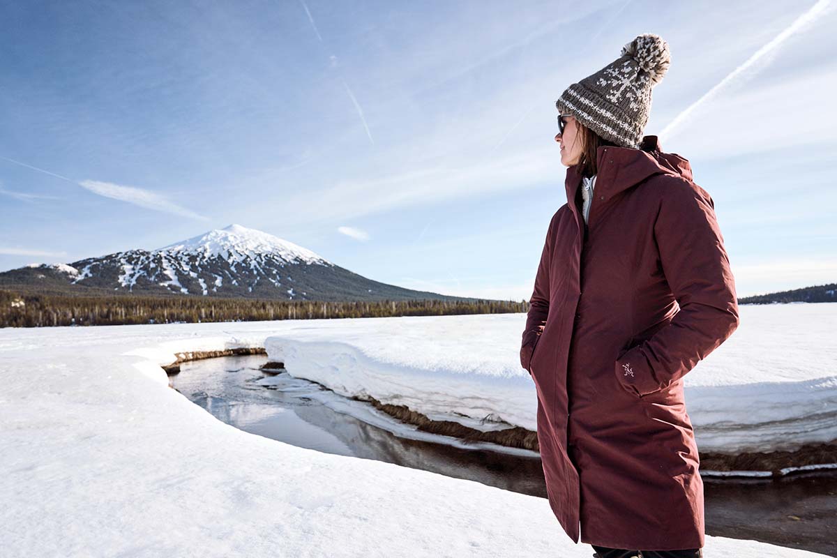 Winter jacket (Arc'teryx Patera Parka standing by mountain)