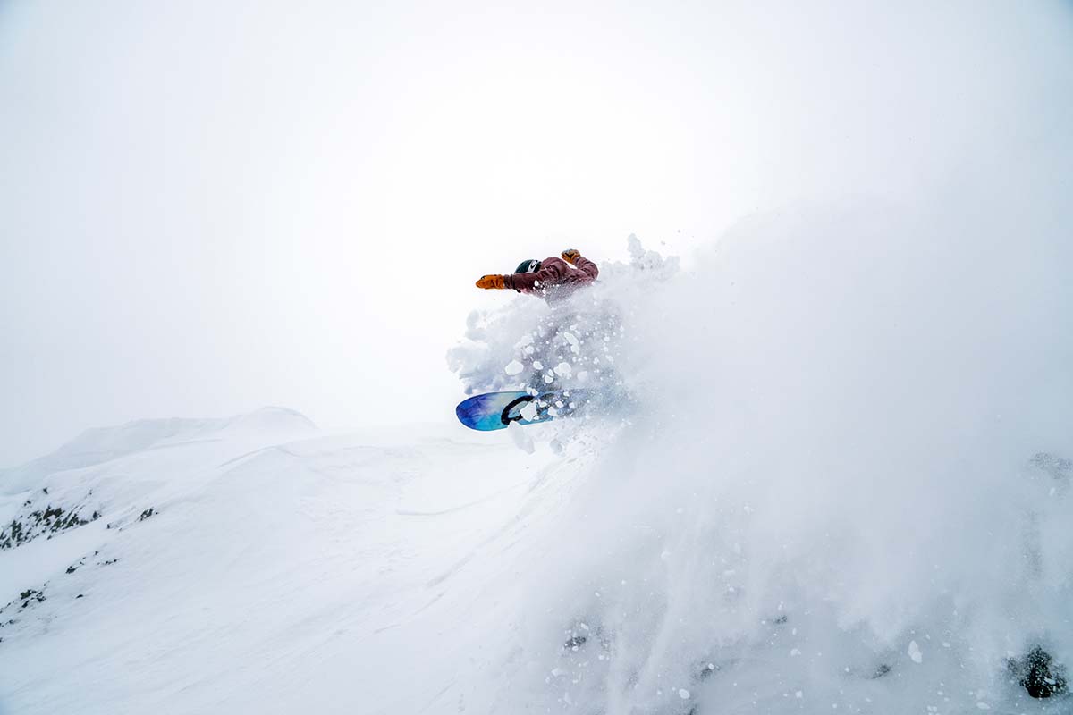 Catching air in the Flylow Fae pant (women's snowboard pants)