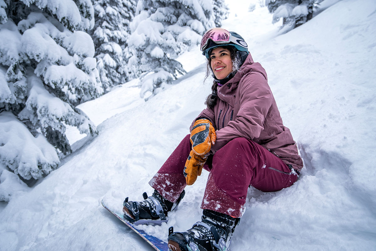 Flylow Fae women's snowboard pants (sitting in snow)