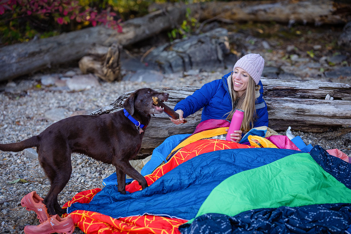 Camping checklist (playing with dog under camping blankets)