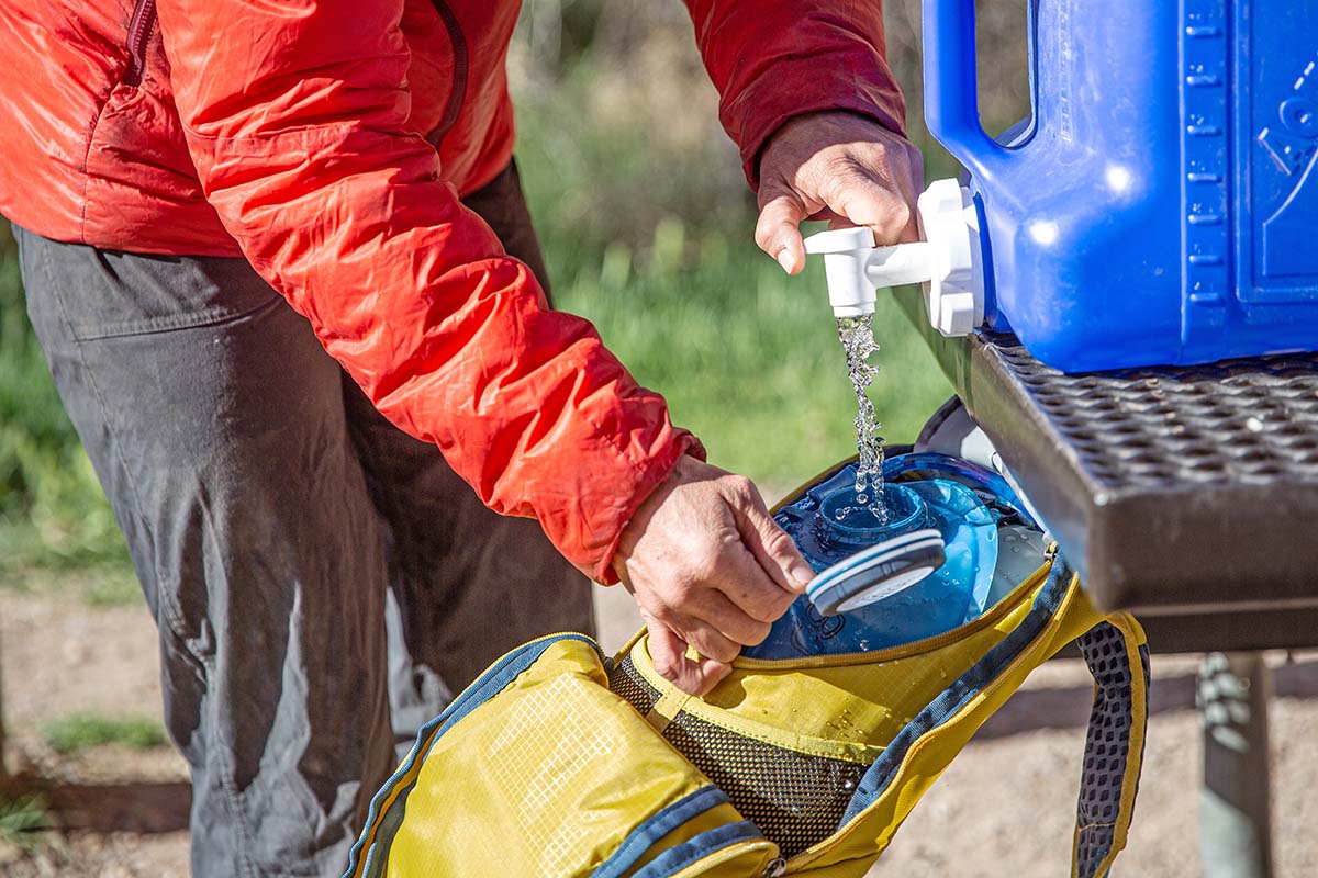 Camping checklist (filling up hydration bladder from water jug)