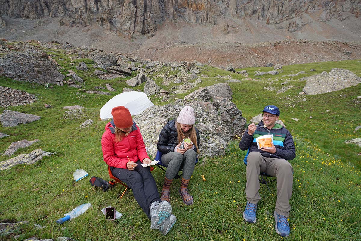 Doing crossword at camp while backpacking (Altra Lone Peak ALL WTHR Mid hiking boot)