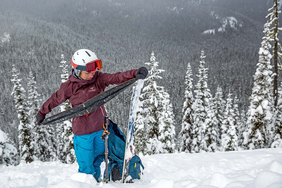 Putting skins on skis in the backcountry (Arc'teryx Beta FL hardshell jacket)