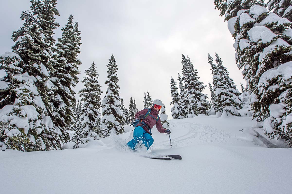 Skiing downhill wearing the Arc'teryx Beta FL hardshell jacket