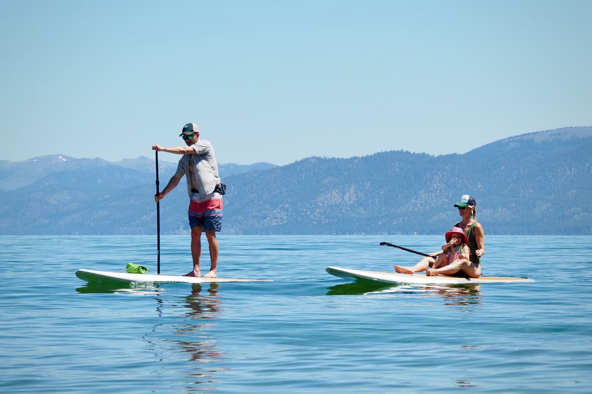 A family paddling the Dax DownDog and Drifter stand up paddle boards on Lake Tahoe
