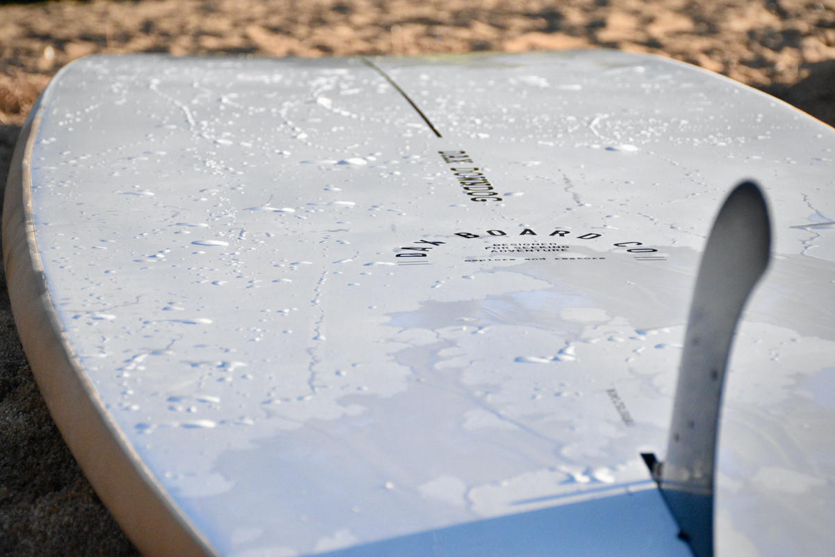 Showing the smooth epoxy bottom surface of the Dax DownDog stand up paddle board