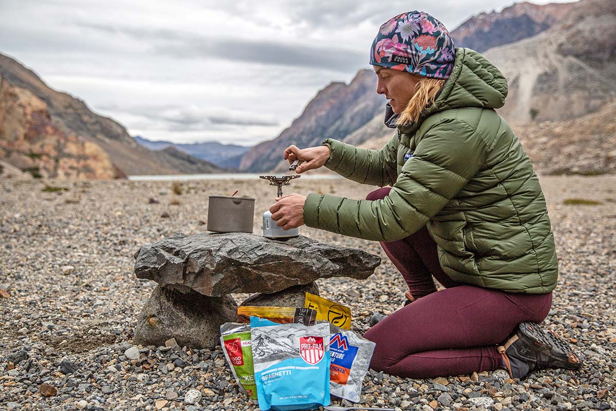 Lighting stove for dinner (Feathered Friends Eos Down Jacket)