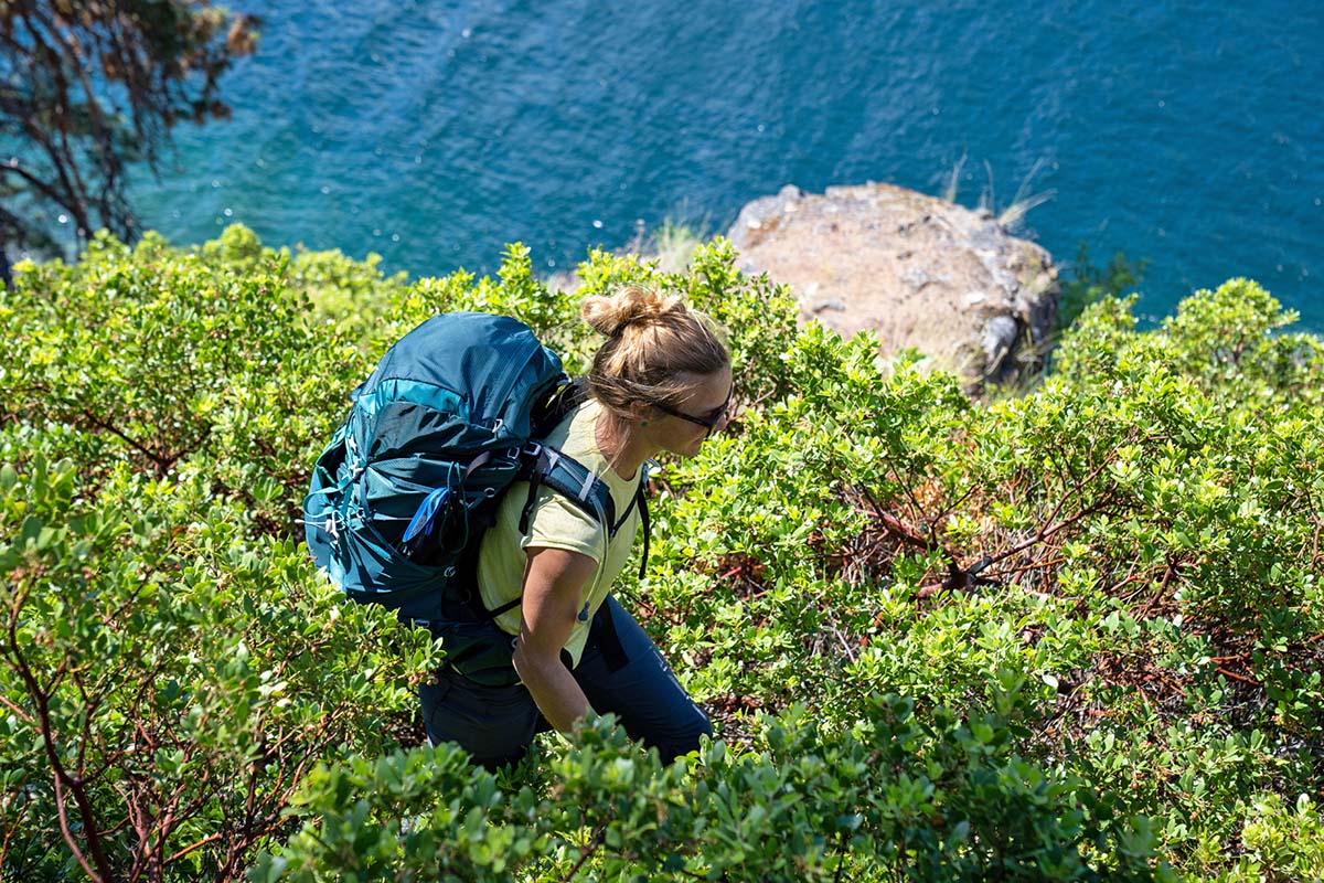 Hiking on trail by lake (Osprey Eja 58 backpack)