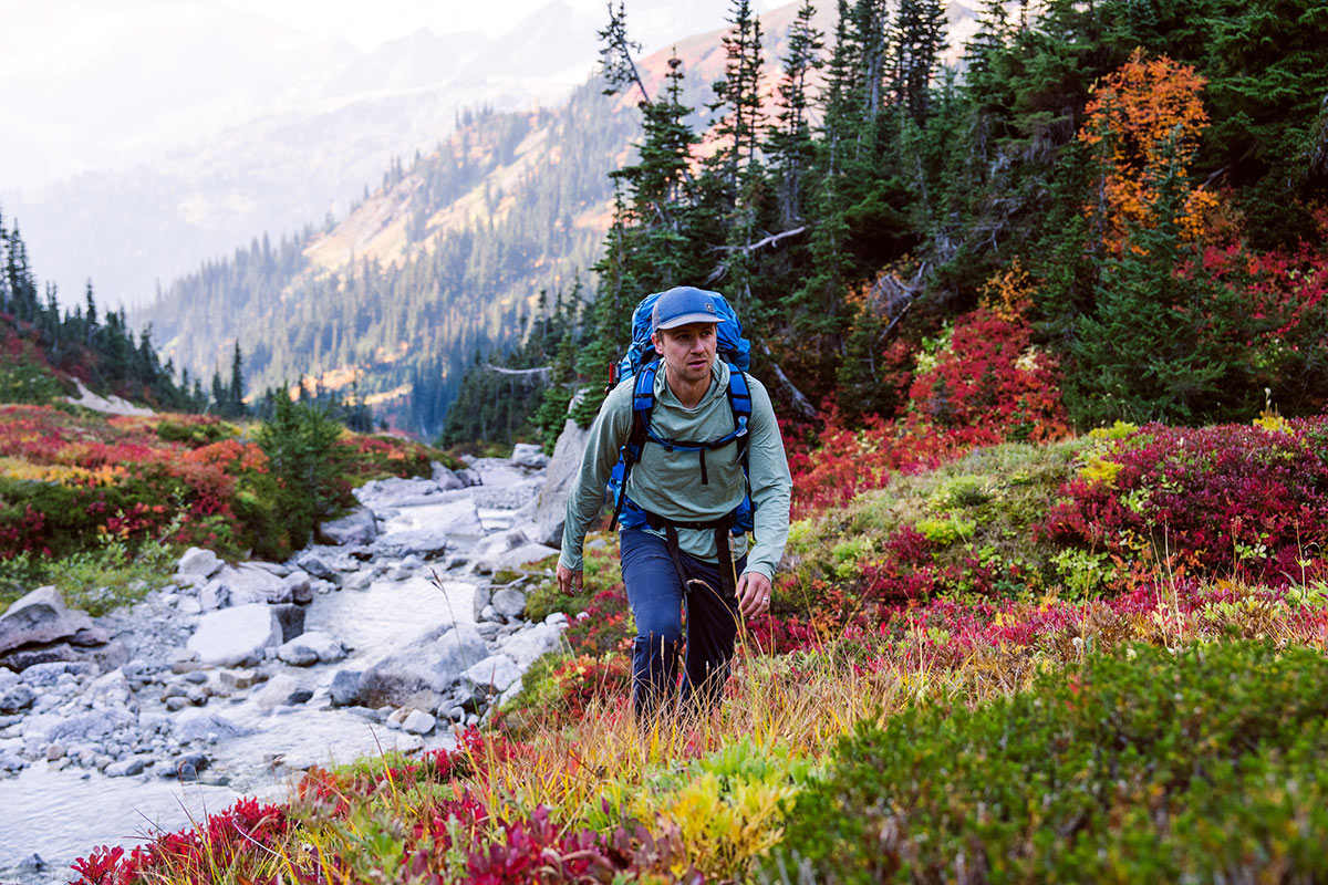 Osprey Exos 58 Backpack (hiking next to a stream)