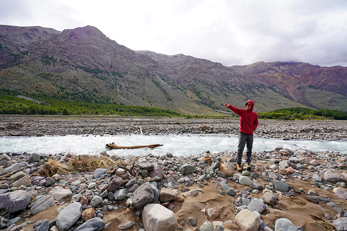 Outdoor Research Refuge Hooded synthetic jacket (pointing by river)