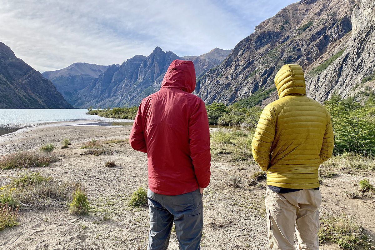 Outdoor Research Refuge Hooded synthetic jacket (standing beside lake)