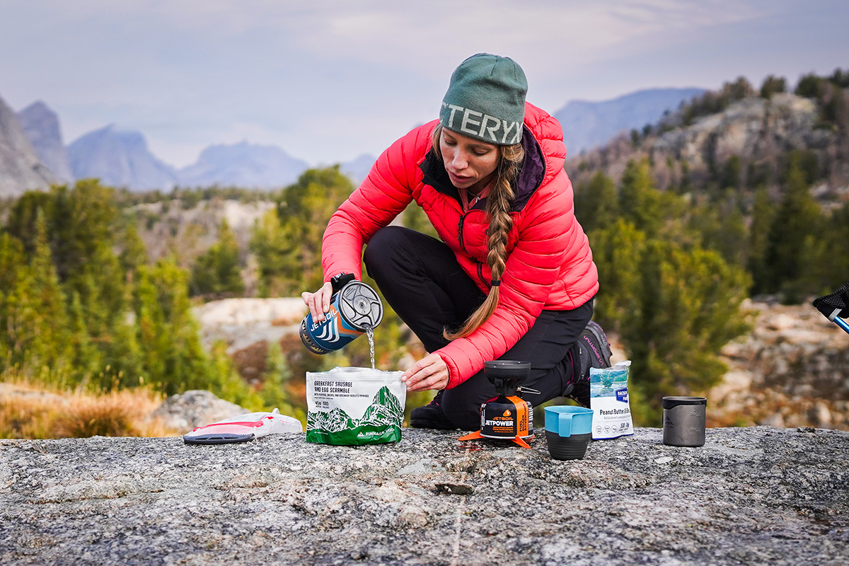 Outdoor Research Transcendent Hoodie (pouring water into dehydrated meal)