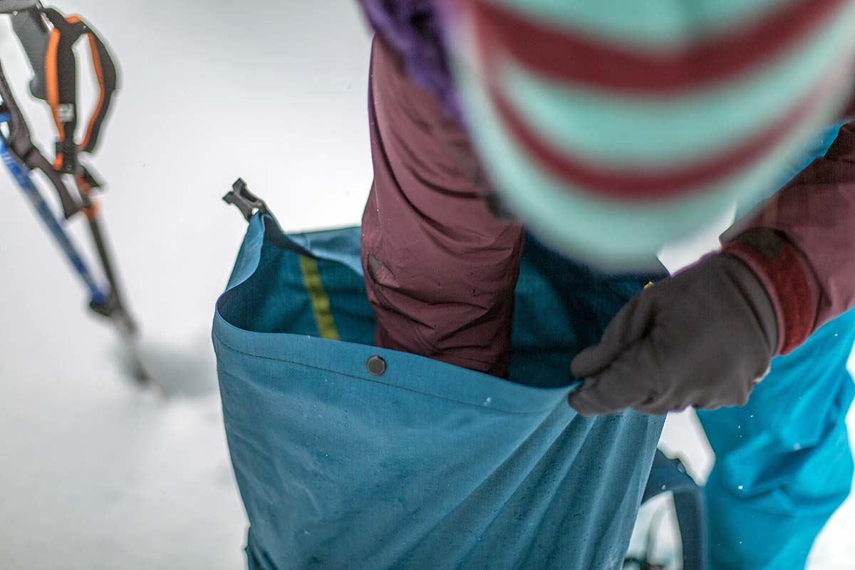 Reaching into main compartment (Patagonia Descensionist 40L ski pack)