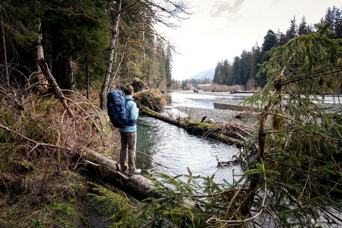 REI Co-op Traverse 60 backpack (standing on log)