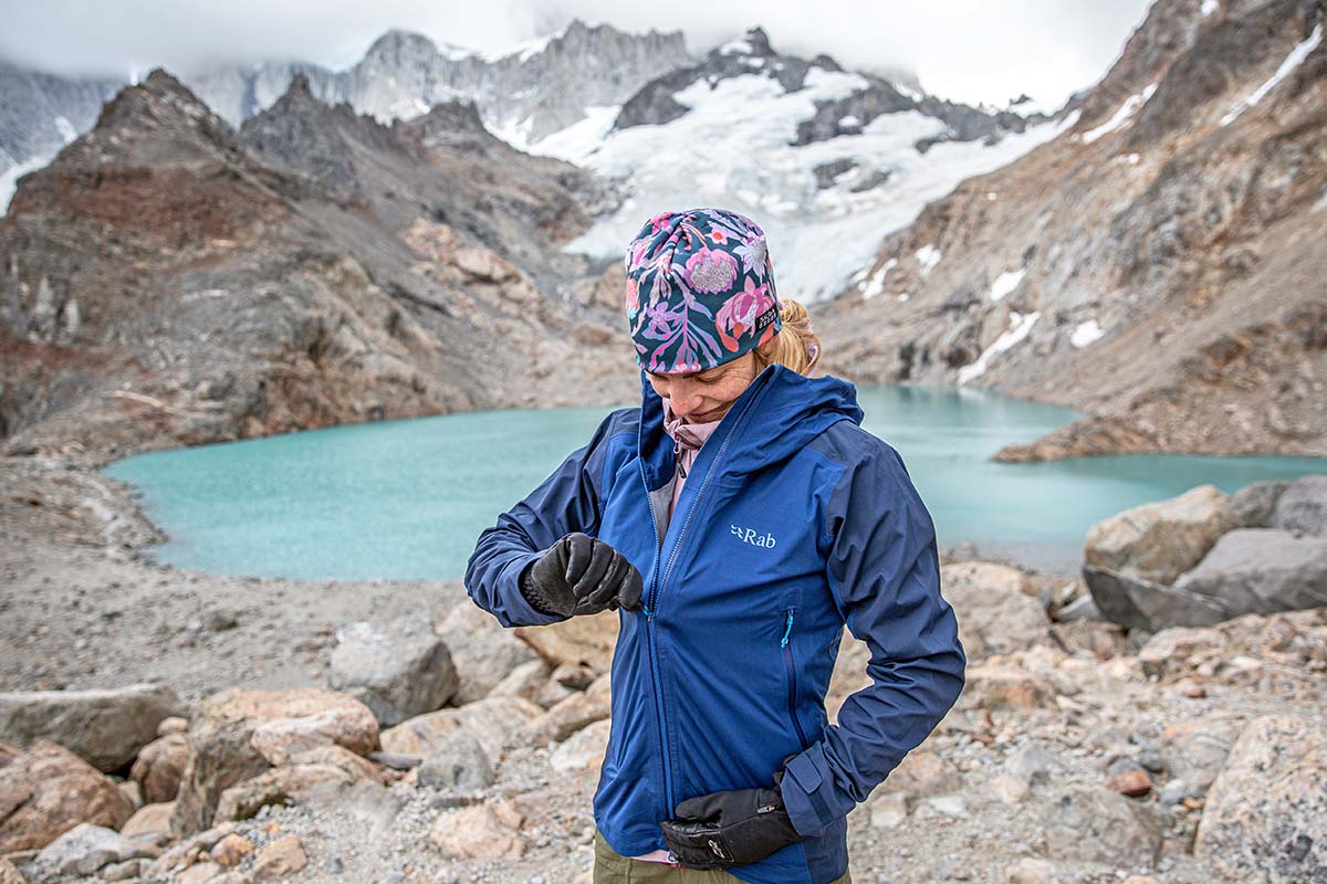 Rab Kinetic Alpine 2.0 jacket (zipping up in front of lake)