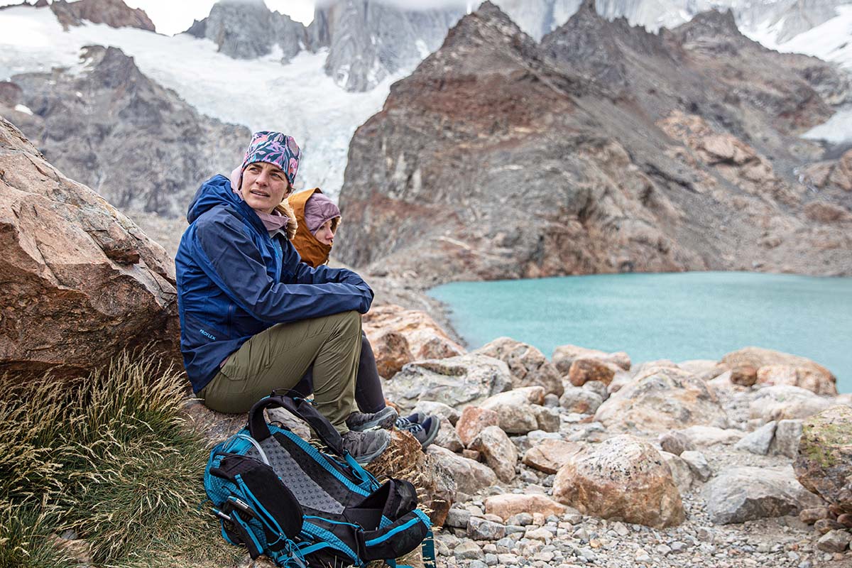 Sitting by lake wearing Salomon X Ultra 4 GTX hiking shoes