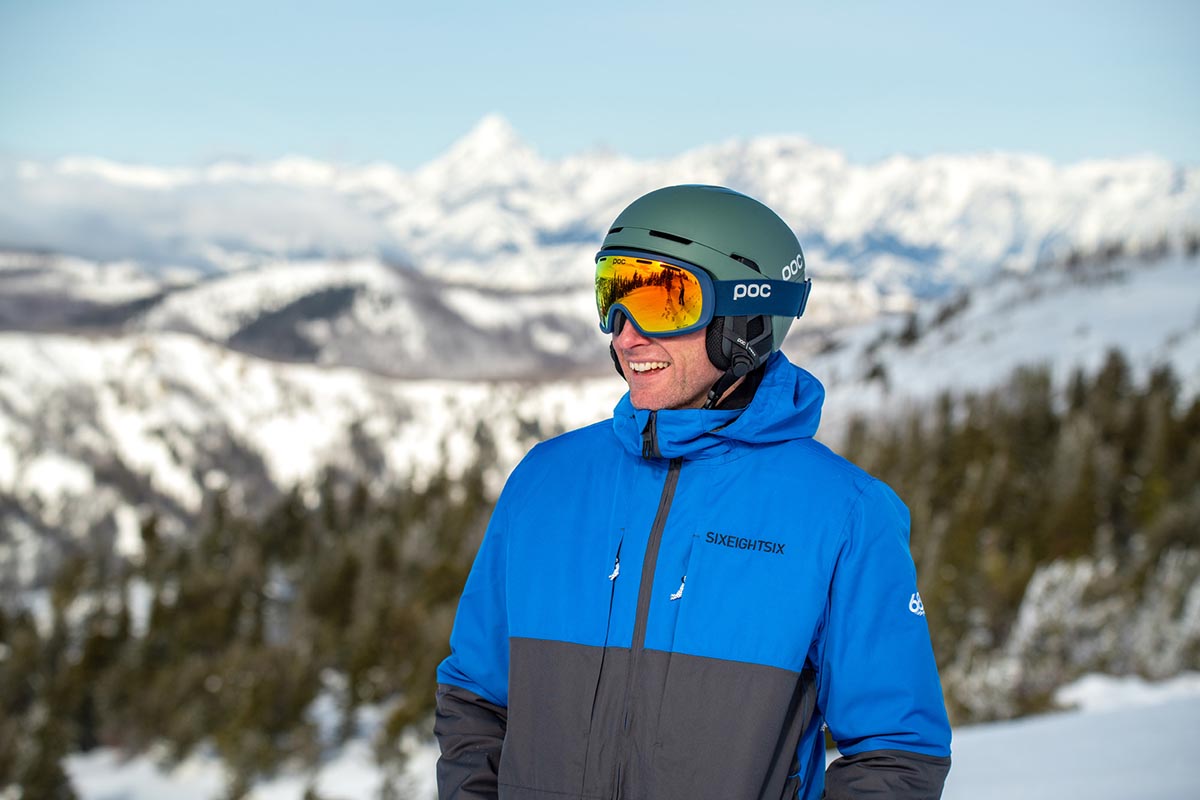 POC Obex Spin ski helmet (standing in front of mountain)