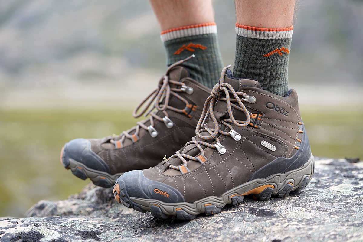 Best hiking footwear brands (Oboz Bridger standing on rock)