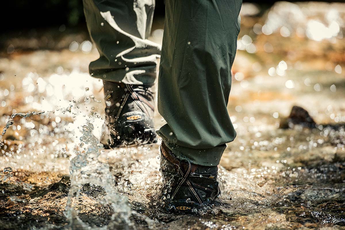 Hiking boot (Keen Targhee III splashing through puddle)