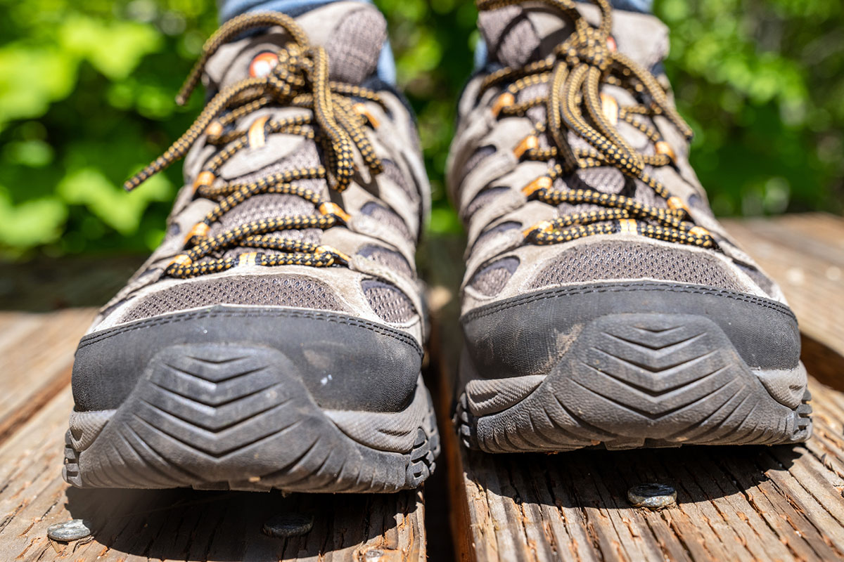 A closeup of rubber toe bumbers on a pair of brown hiking shoes
