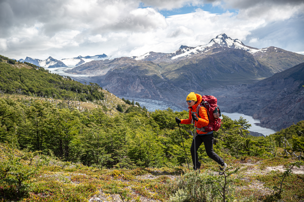 A woman backpacking through alpine terrain