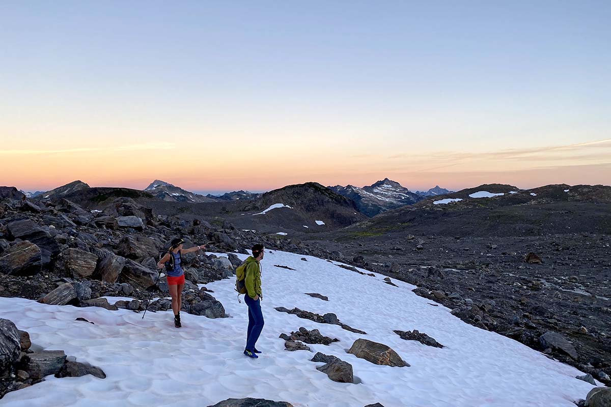 Pointing out route at dawn (mountain running)