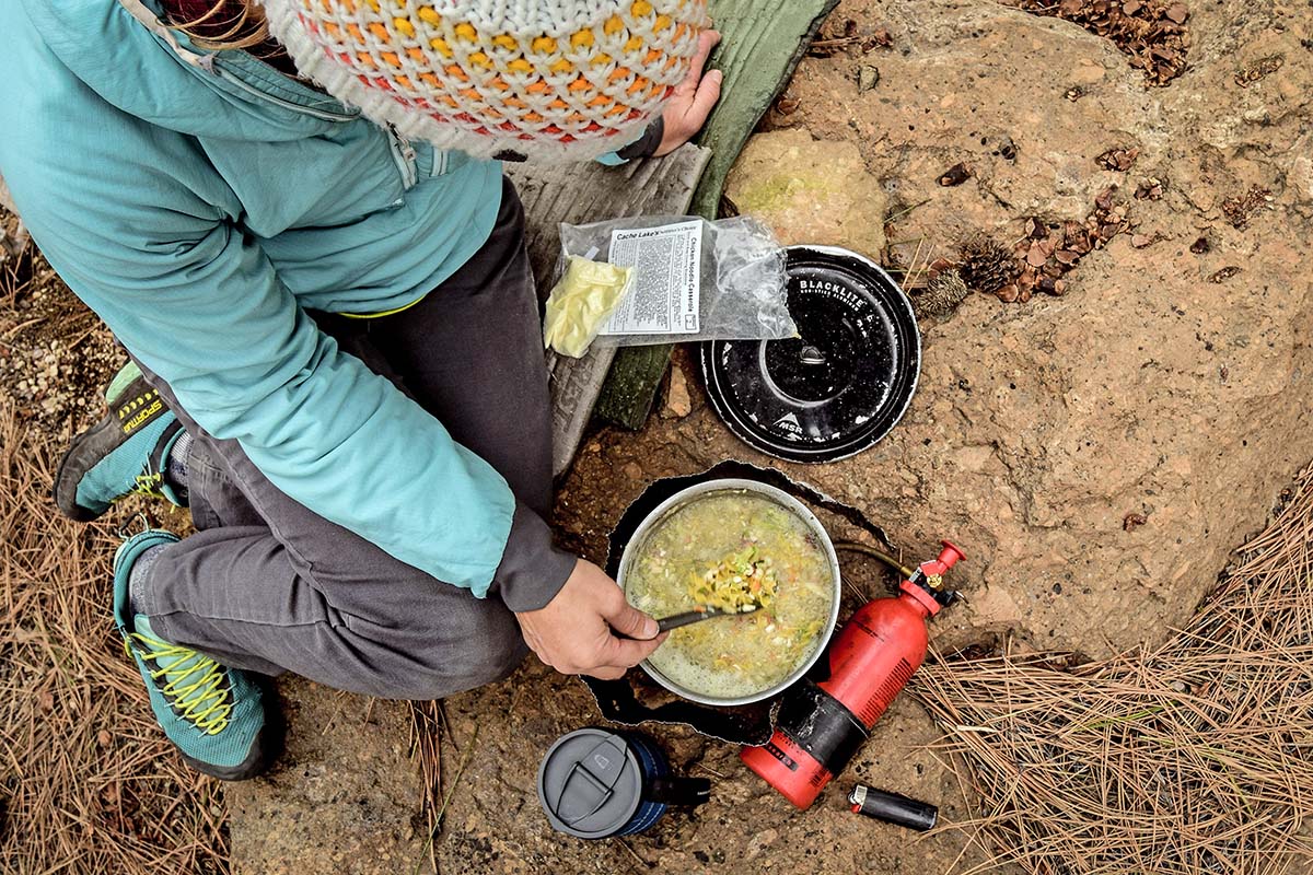 Cooking meal over MSR Whisperlite (How to Choose a Backpacking Stove)