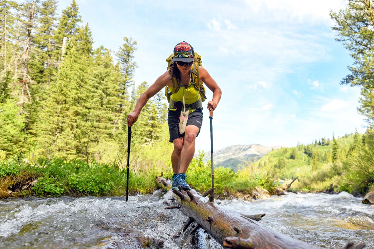 Backpacking across a river on a narrow log